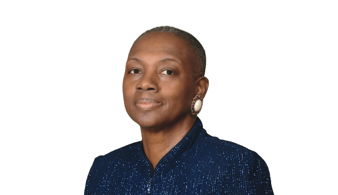 A person with short hair, exuding leadership, wearing a blue sequined top and earrings against a green background.