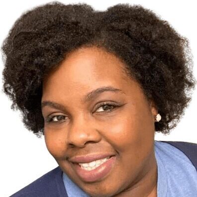 A woman with big hair smiling for the camera.